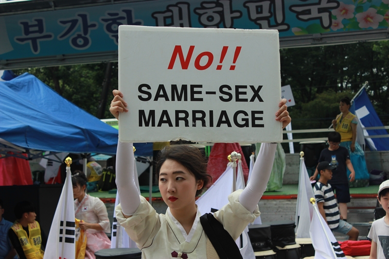 ▲ 동성애퀴어축제반대국민대회가 14일 서울 대한문 일대에서 퀴어축제를 반대하는 집회를 열고 있다. 사진은 대한문 인근 부스에서 피켓을 들고 있는 참가자. 사진=이우림 기자